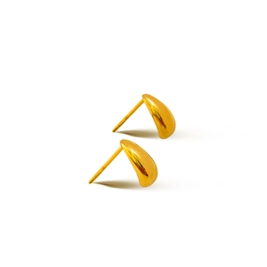 Detailed macro view of polished gold teardrop stud earrings with smooth mirror finish