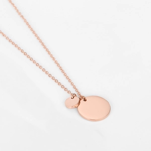 Macro view of rose gold polished round pendant necklace detail with double discs