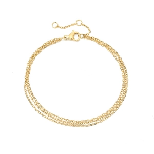 Detailed macro view of triple-layered gold chain bracelet with secure lobster clasp