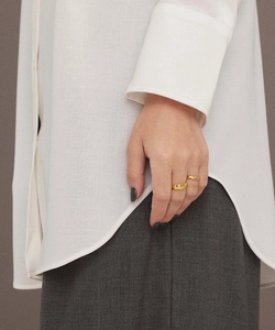 Close-up of minimalist gold plated stainless steel ring set on a model hand