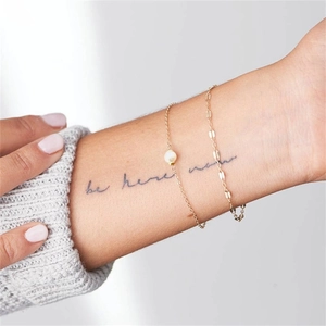 Double-layered gold chain bracelet set with pearl accent on minimalist stainless steel links