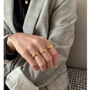 Polished gold-plated stainless steel rings and round pendant necklace on model