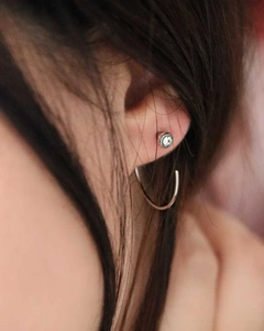 Macro shot of silver stainless steel stud and hoop earrings with sparkling cubic zirconia