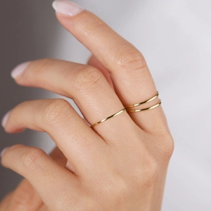 Minimalist gold-plated stainless steel stackable rings for women shown in a layered style