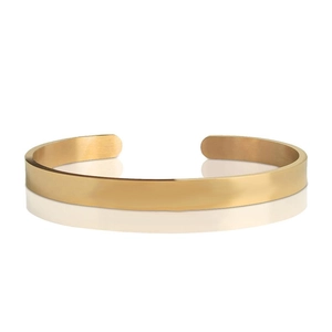 Detailed close-up of a minimalist gold-plated stainless steel open cuff bracelet on white