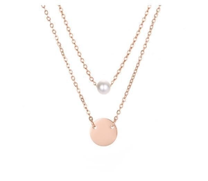 Detail of double-layer rose gold necklace with white pearl and solid round pendant