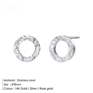 Macro detail of 8mm round stainless steel earrings with textured hammered finish