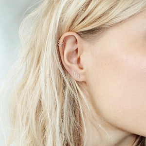 Minimalist double-layer silver stainless steel ear cuff and stud earrings on model