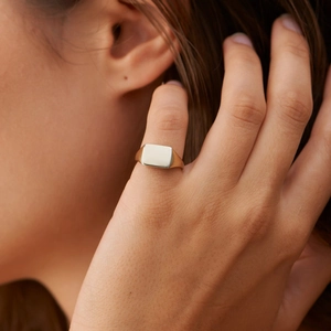 Minimalist gold-finish rectangular signet ring in stainless steel for women on hand