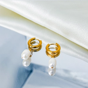 Detail of 14K gold plated hoop earrings with natural freshwater pearl drops on silk