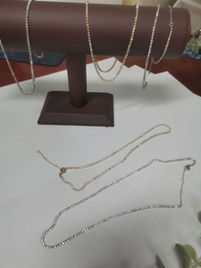 Close-up of gold and silver tennis chains with lobster clasp and extension links