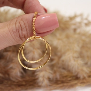 Detailed close-up of golden double-ring pendant showing the S925 sterling silver stamp