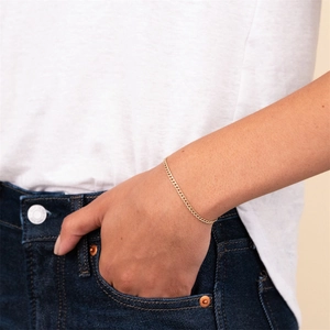 Close-up of 14k gold plated stainless steel curb chain bracelet on model wrist
