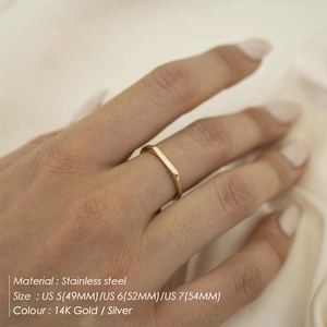 Size chart for minimalist 14K gold and silver stainless steel rings on silk background