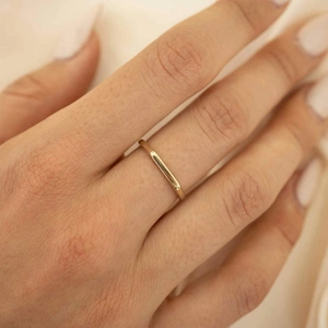 Minimalist 14K gold-plated titanium steel ring with a polished finish shown on a finger
