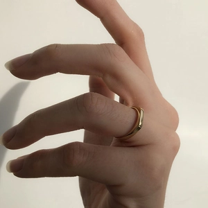 Detailed close-up of a minimalist 18K gold plated rectangular signet ring on a finger