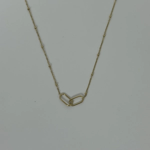 Detail of a golden satellite chain necklace featuring interlocking geometric paperclip rings
