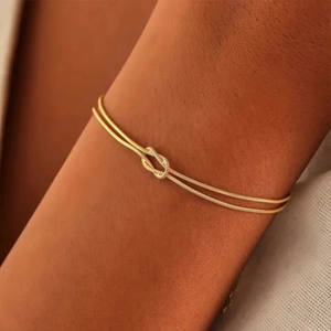 Minimalist gold plated snake chain bracelet featuring a stylish knot design for women
