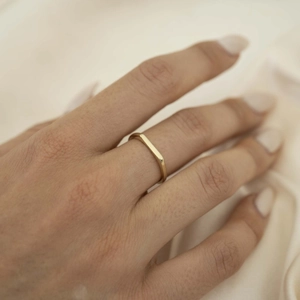 Minimalist 18K gold plated rectangular bar ring shown on finger against silk background