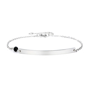 Detailed view of silver stainless steel chain bracelet with a bar and black bead detail