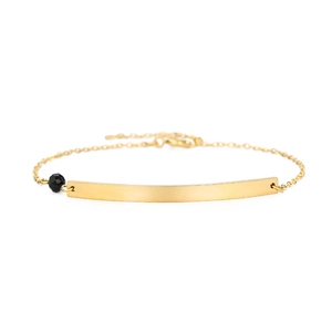 Minimalist gold titanium steel bracelet with polished bar and black gemstone bead accent