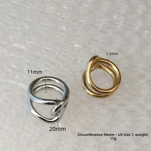 Macro detail of intertwined organic rings in gold and silver showing 54mm circumference