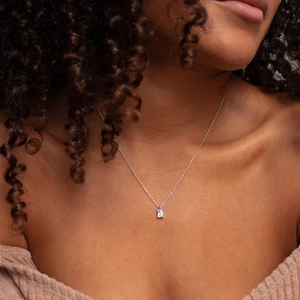 Elegant model shot of silver chain necklace with rectangular zircon pendant detail