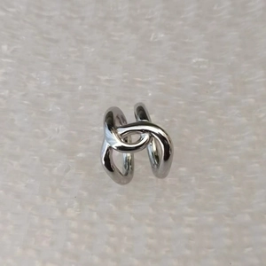 Close-up of minimalist silver intertwined rings with a high-polished mirror finish