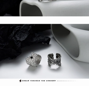 Macro shot of S925 sterling silver wide ring with lava texture and black gemstone