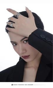 Detailed view of irregular silver lava texture rings with black gemstones on model