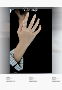 Detail showing S925 sterling silver rings with blue zircon and cone charm on hand