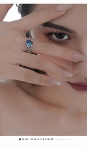 Detail of S925 silver ring featuring irregular lava texture and pear-shaped blue gemstone