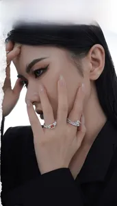 Close-up of S925 silver textured rings with orange gem and clear zircon on a model