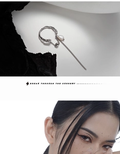 Detail of silver lava-textured ear cuff with a natural pearl and long tassel chain
