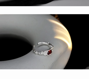 Detailed view of S925 silver ring featuring raw rock texture and a red gemstone inlay