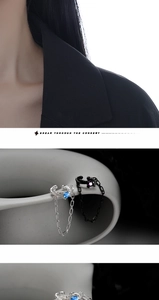 Détails macro des bagues d'oreilles en argent S925 avec chaîne et pierres serties