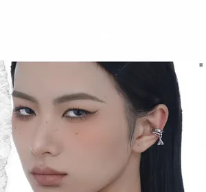 Close-up of S925 sterling silver chain ear cuff with sparkling triangle zircon drop