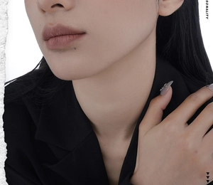 Detail of matte bean paste lip glaze paired with a professional black tailored blazer