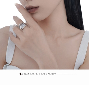 Detailed view of silver textured lava ring featuring a rectangular cut cubic zirconia