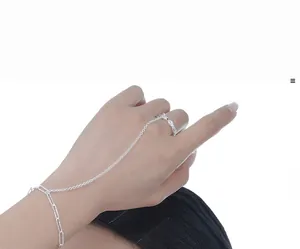 Detail of S925 sterling silver finger ring bracelet with textured thin chain design