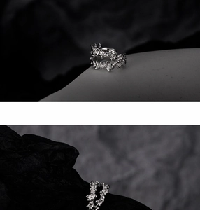 Macro detail of S925 silver ear cuff showing irregular lava texture and white zircons