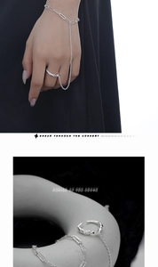 Macro detail of S925 silver slave bracelet featuring lava texture ring and paperclip chain