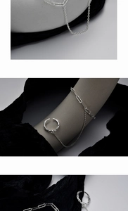 Detailed view of silver chain ring with irregular texture on a modern artistic background