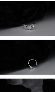 Detailed view of the irregular lava texture and silver finish on this adjustable ring