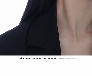 Close-up of a premium black notched lapel suit jacket with fine twill fabric texture
