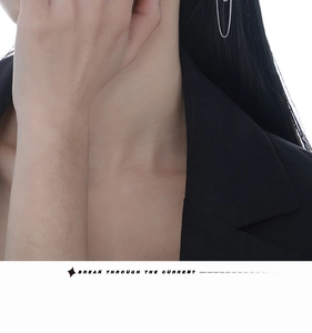 Macro view of S925 sterling silver chain ear cuff earring on model for modern style