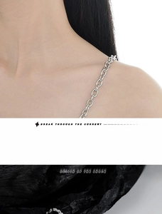 Detailed close-up of S925 sterling silver long chain tassel earring with emerald accents