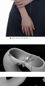 Detail of double-layer silver bracelet featuring pink baroque pearls and long tassels