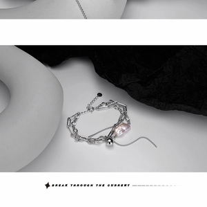 Detailed shot of S925 silver multi-layered chain bracelet with baroque pearl and metal ball