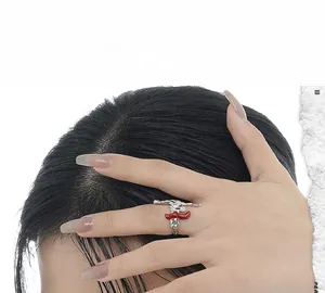 Macro shot of silver irregular S925 ring with bold red enamel accent in dark aesthetic